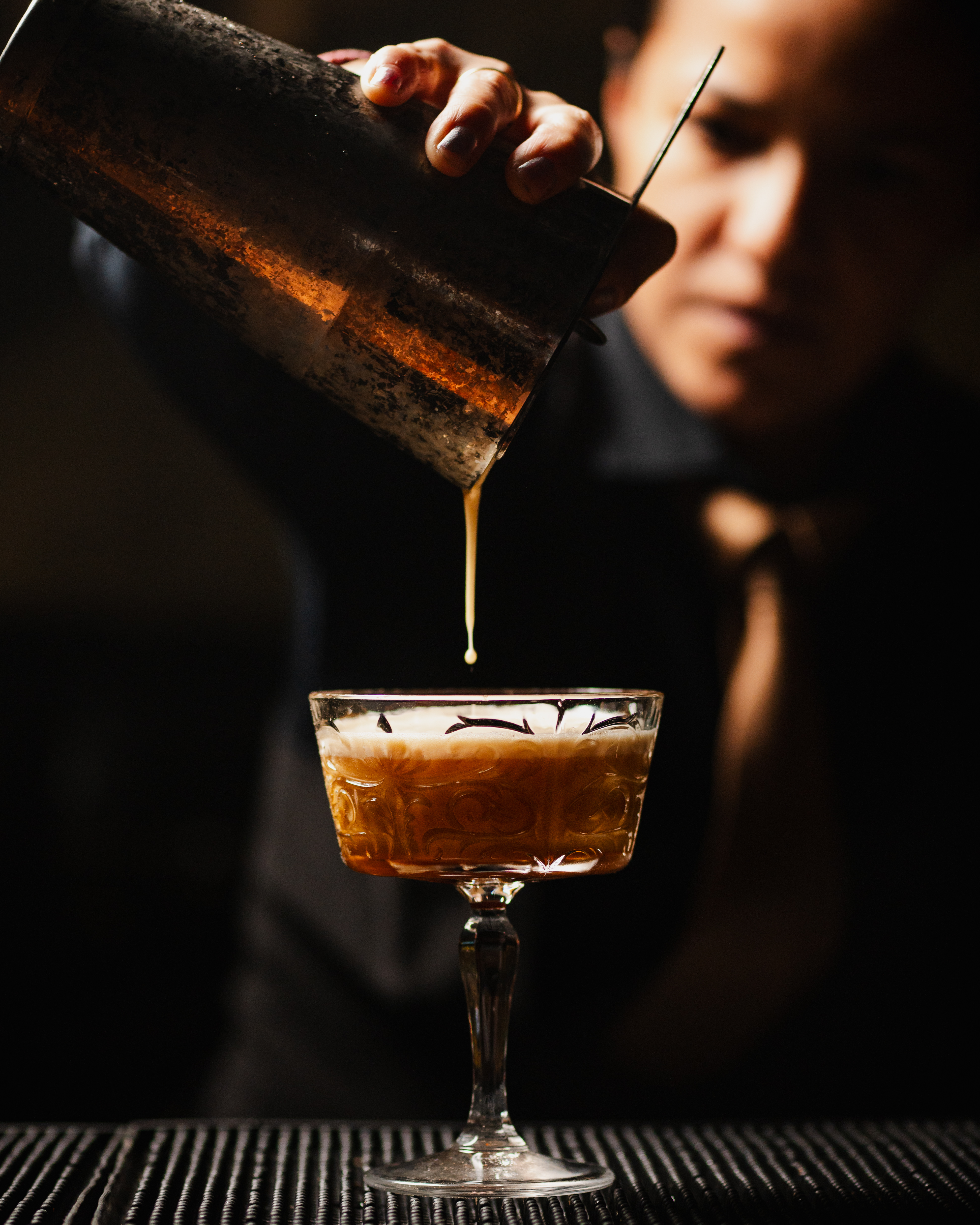 Bartender pouring coupe cocktail at The Bunker San Antonio